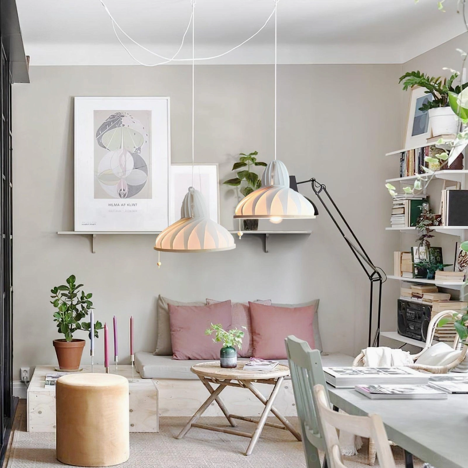 Dual Meblo wave pendant lights in open Scandinavian minimalist home lounge and workspace, multiple hanging fixtures above seating area