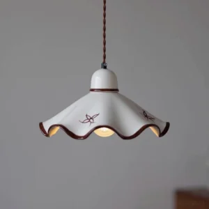 Medium-sized ceramic pendant lamp showing interior bulb socket and twisted brown cord, three-quarter angle