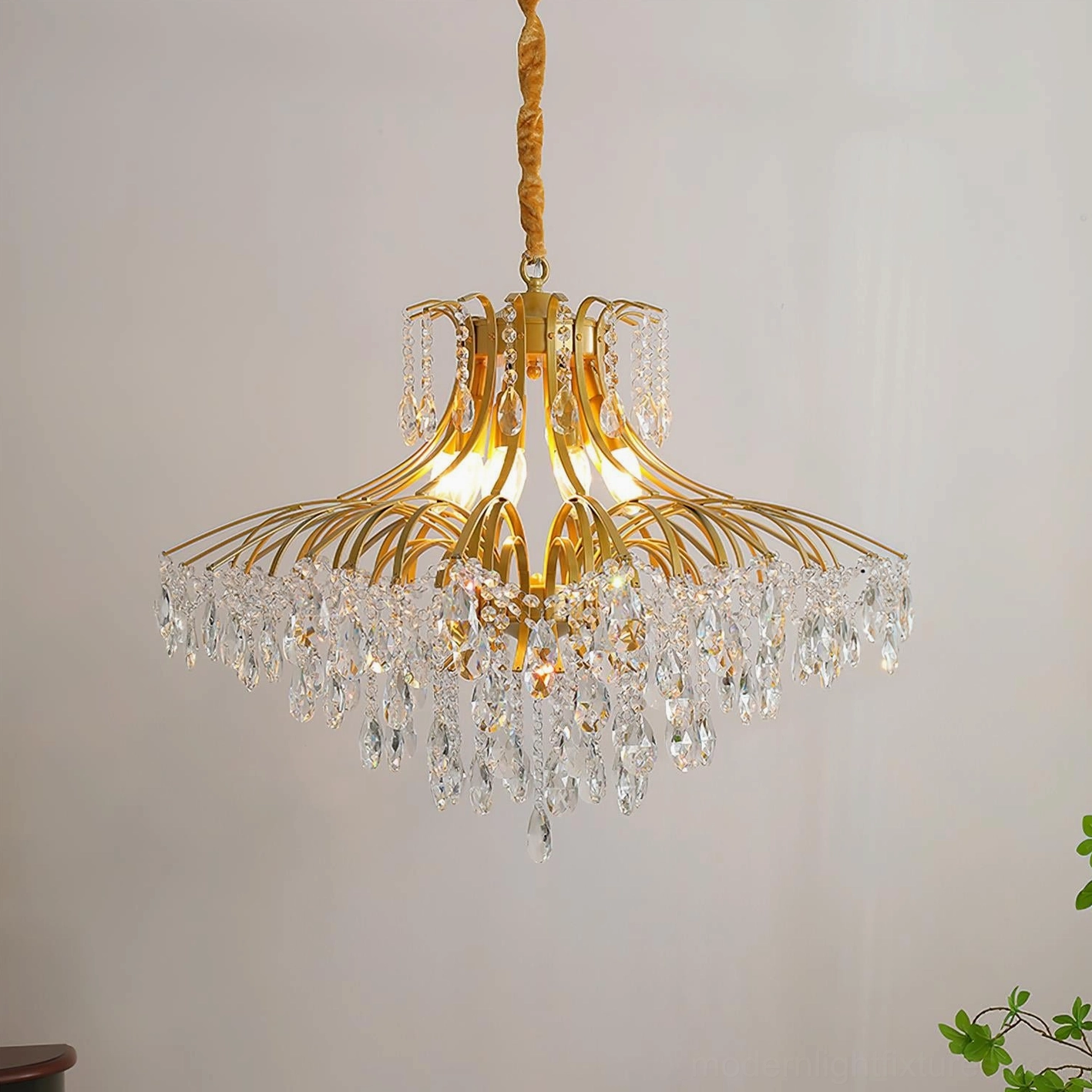Medium-sized wisteria chandelier with tiered crystal drape and gold metal framework architectural detail