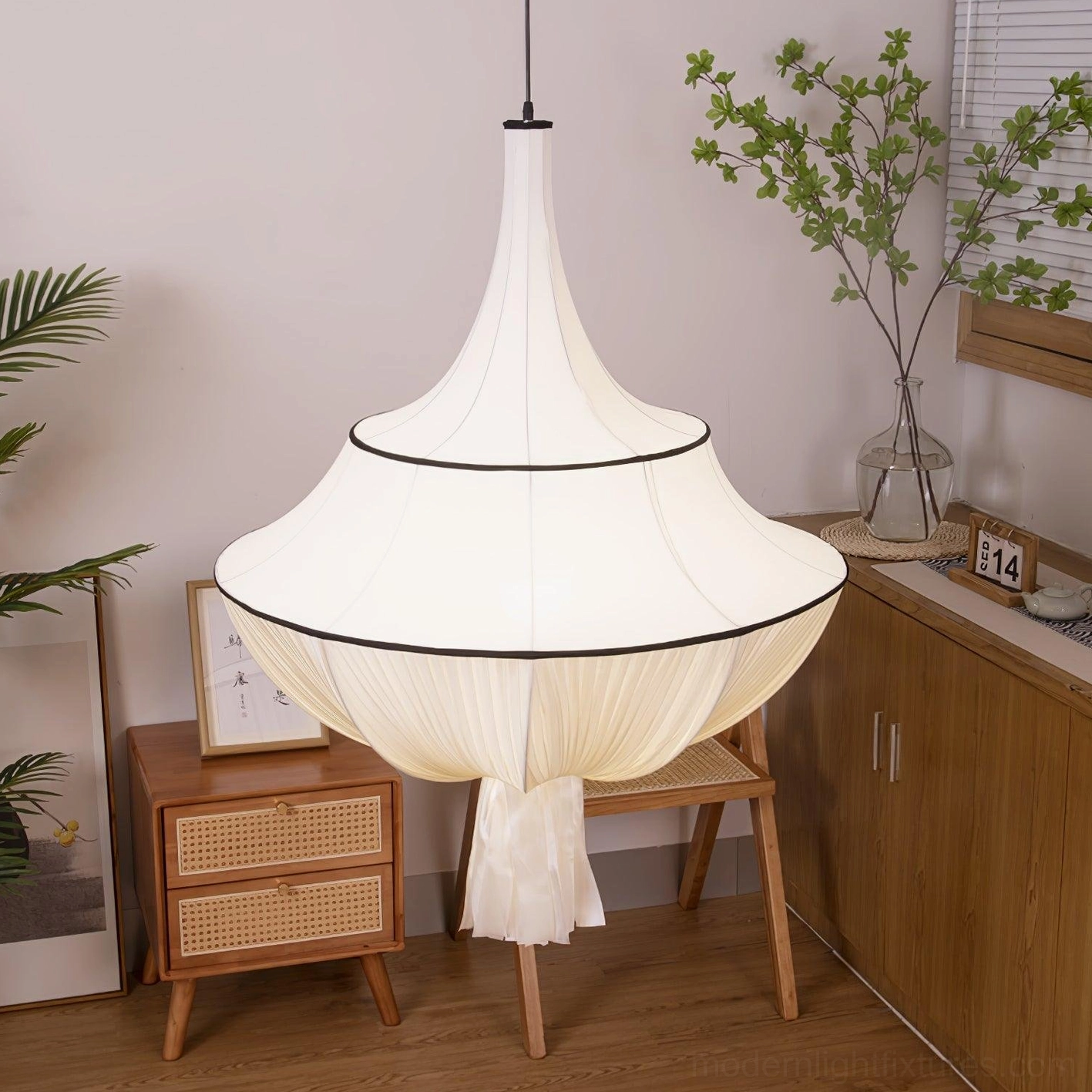 Modern pendant lamp with wide tiered pleated fabric in Japanese-style dining area with wooden furniture