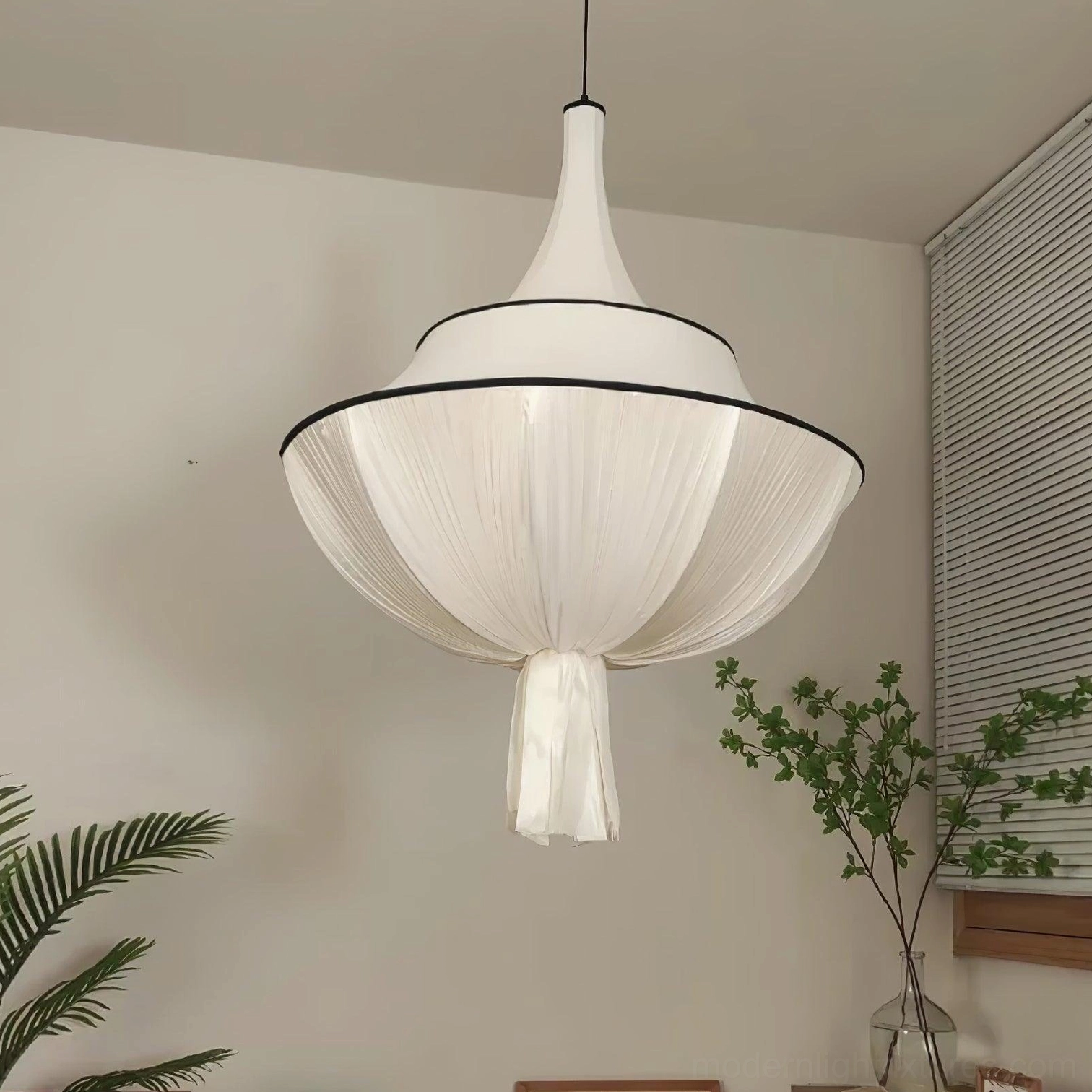 Meduse pendant light with off-white pleated shade, black metal accents and decorative tassel