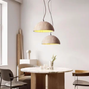 Dual melina travertine pendant lights hanging in modern dining room with wooden table