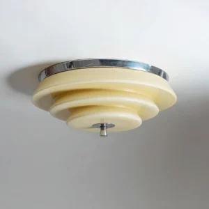 Mellow tiered ceiling light close-up side profile showing polished chrome canopy and finial