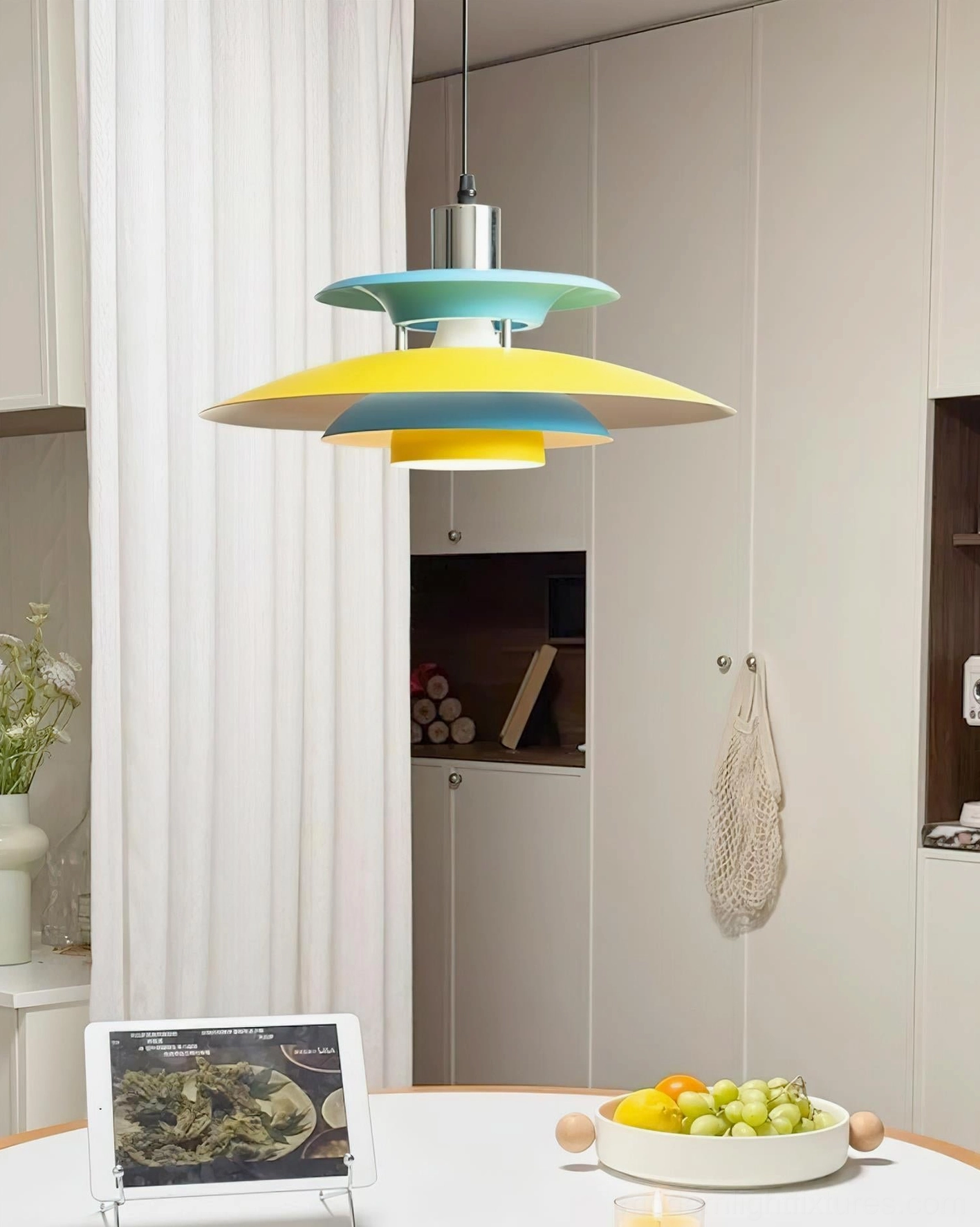 Mellowe colorblock pendant light hanging above white round dining table in contemporary kitchen, side view
