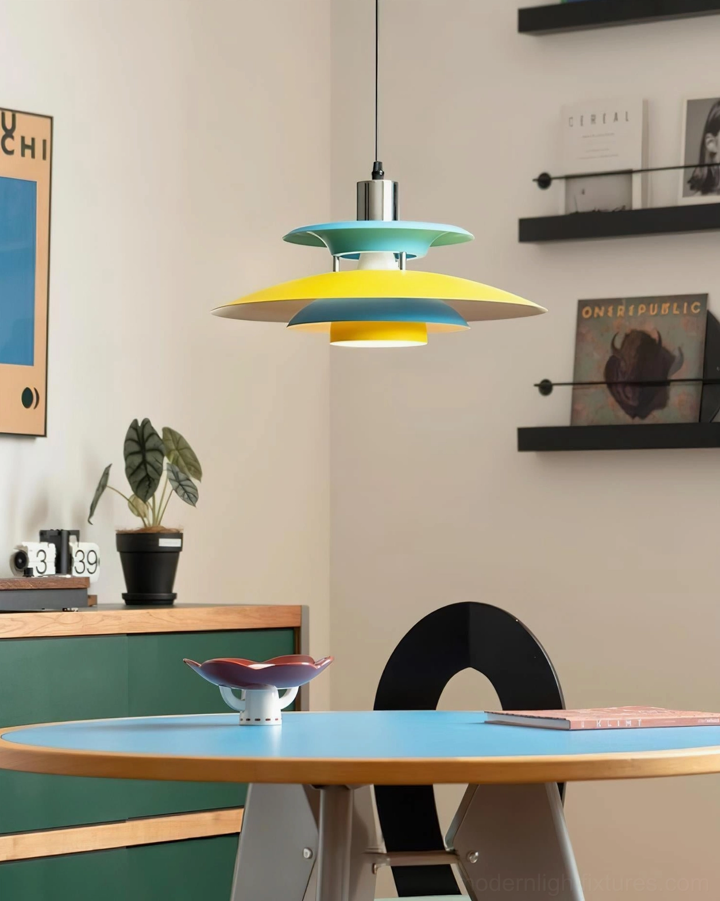 Mellowe modern pendant light installed overhead above round wooden dining table in residential setting