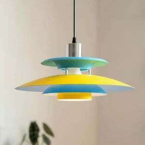 Three-quarter view of Mellowe pendant lamp showing layered yellow and cyan aluminum disc structure with chrome ceiling mount hardware