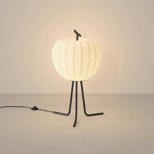 Illuminated Melora modern floor lamp showing warm light diffusion through ribbed shade at low angle view
