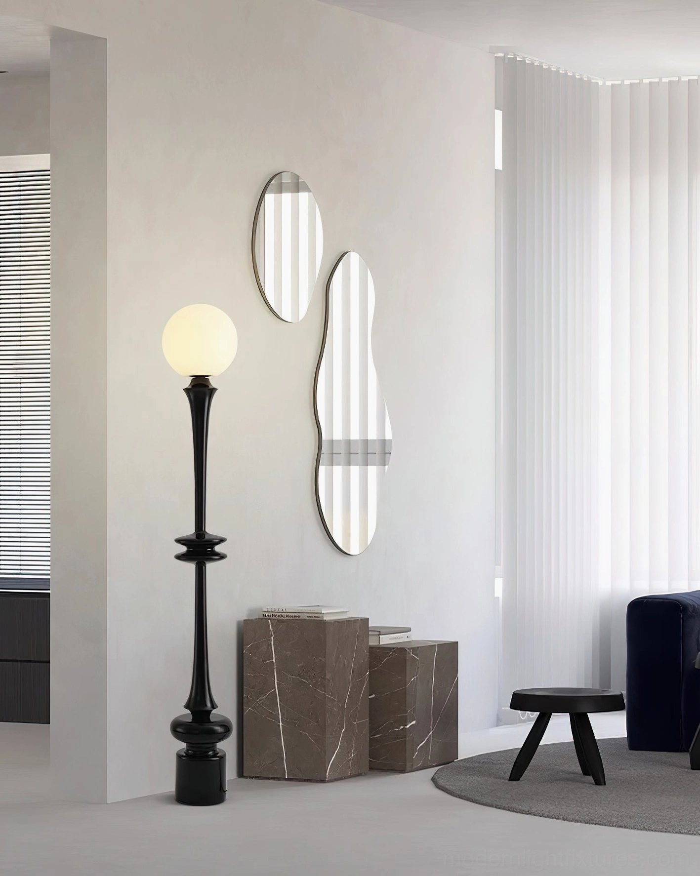 Black orb floor lamp in minimalist corner setting with wall mirrors and stone accent table