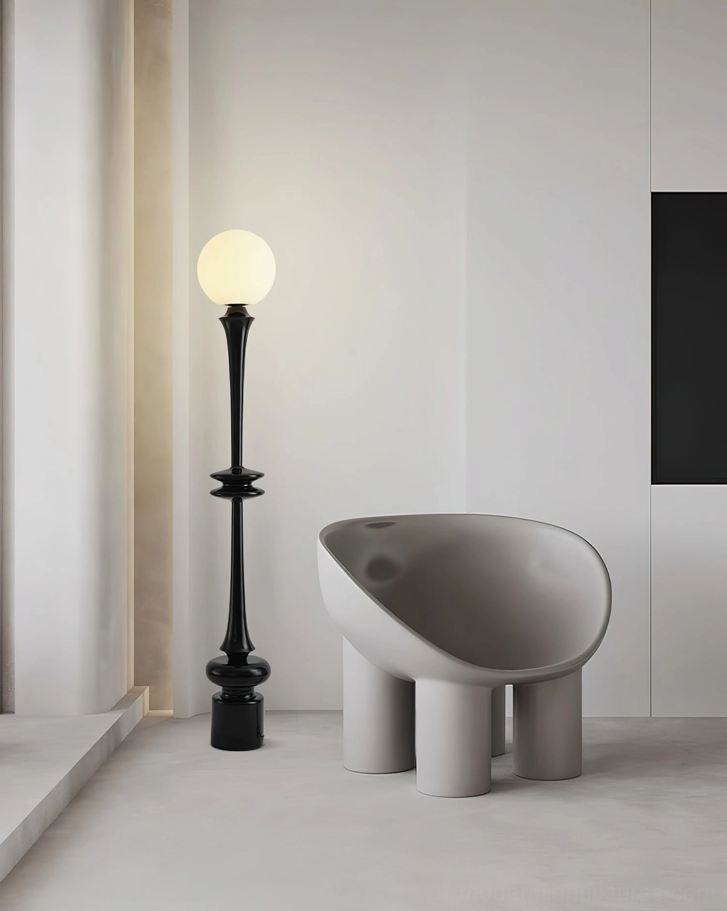 Sleek black spherical floor lamp in minimalist living space with modern chair