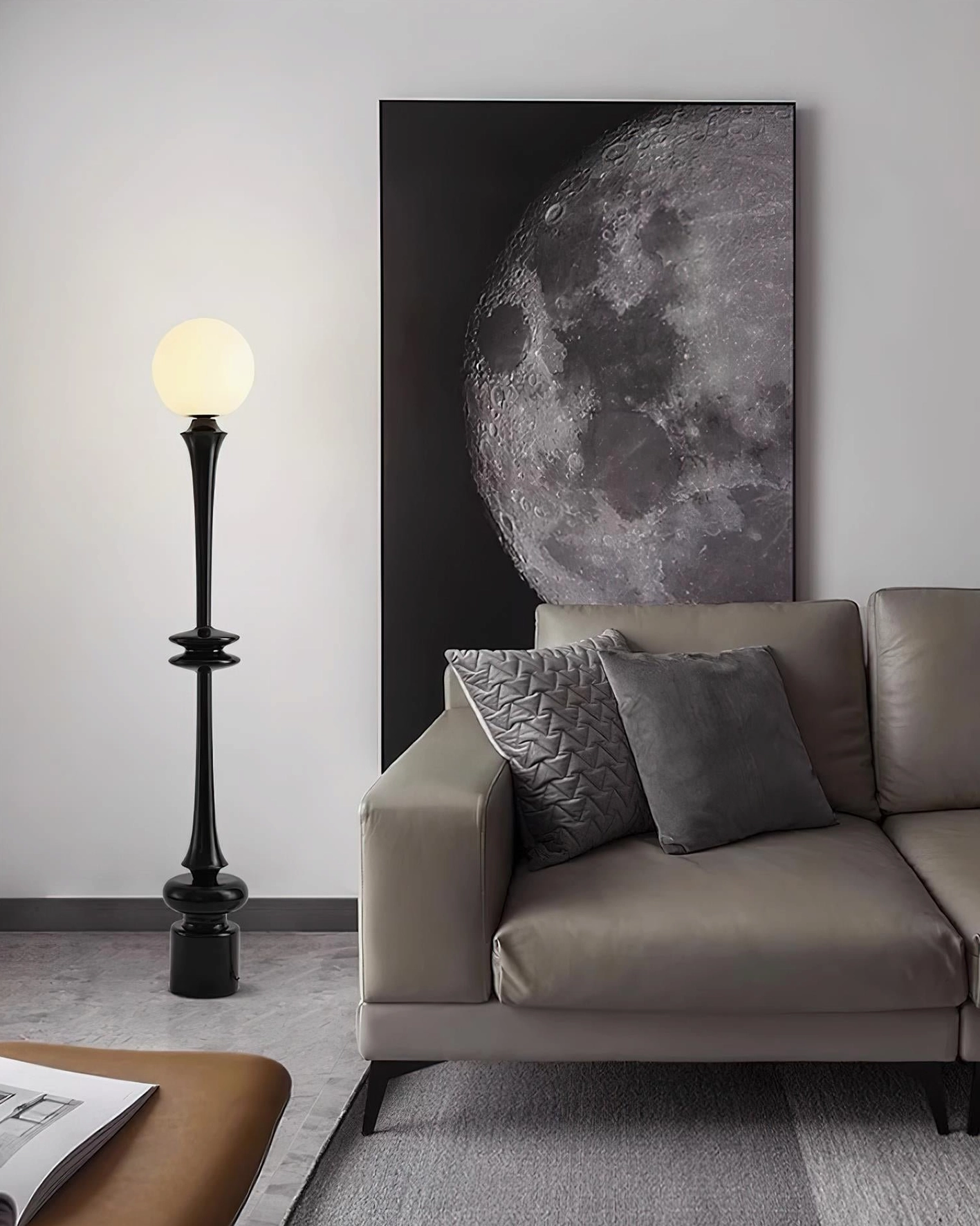 Contemporary black spherical floor lamp in modern living room beside sofa and wall art