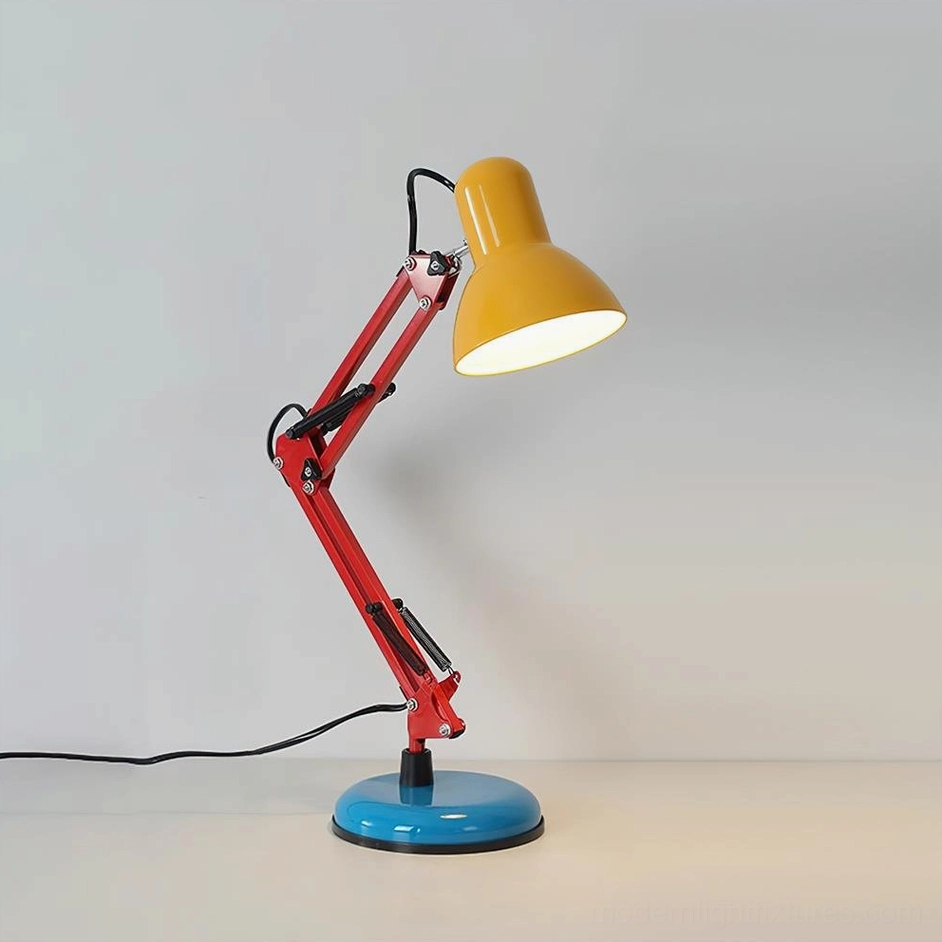 Memphis-style desk lamp three-quarter angle showing yellow lampshade, red mechanical arm joint, and blue metal base with visible power cord - compact modern task lighting