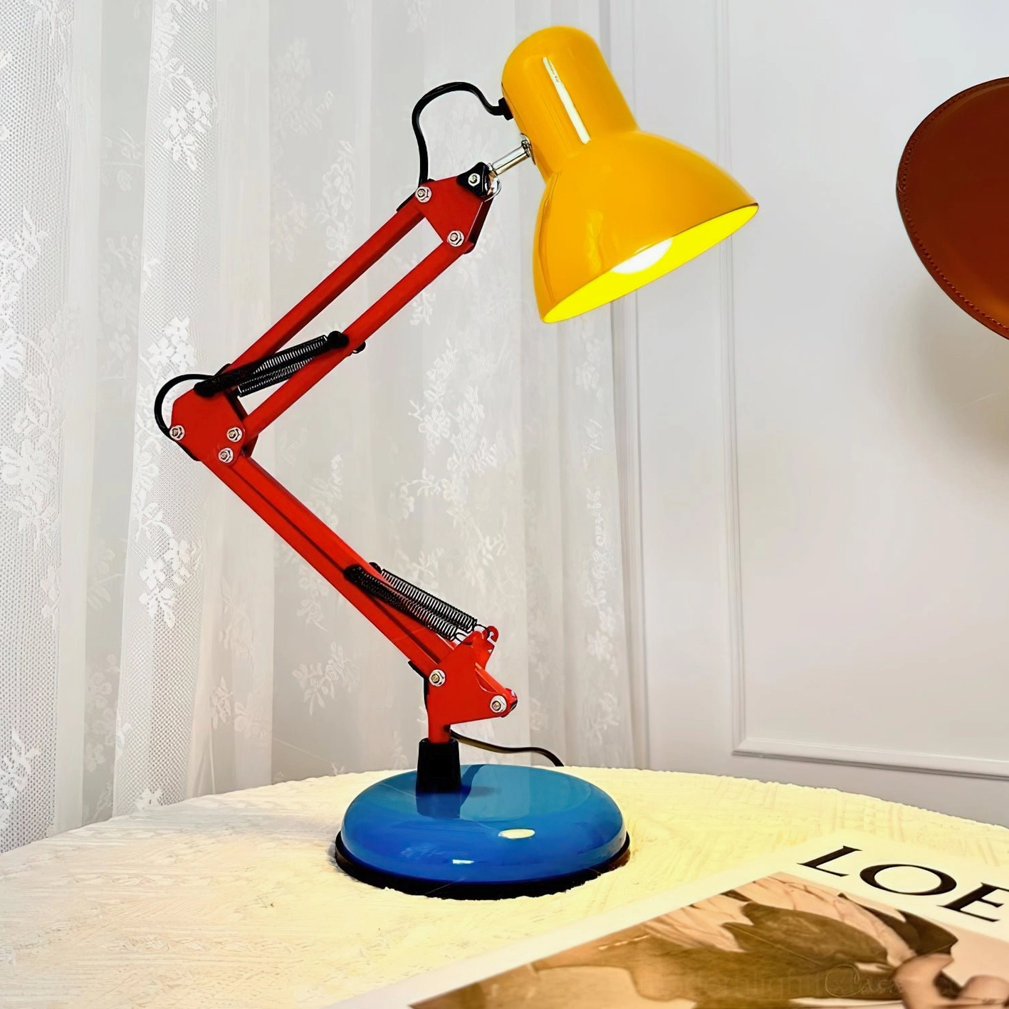 Memphis-inspired desk lamp placed on side table by sheer curtains with soft natural daylight - postmodern bedroom nightstand lighting