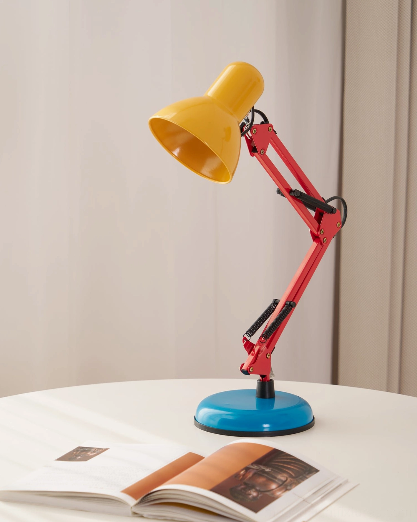 Memphis table lamp construction detail showing red metal arm joint and mechanical articulation - durable modern postmodern desk lamp engineering