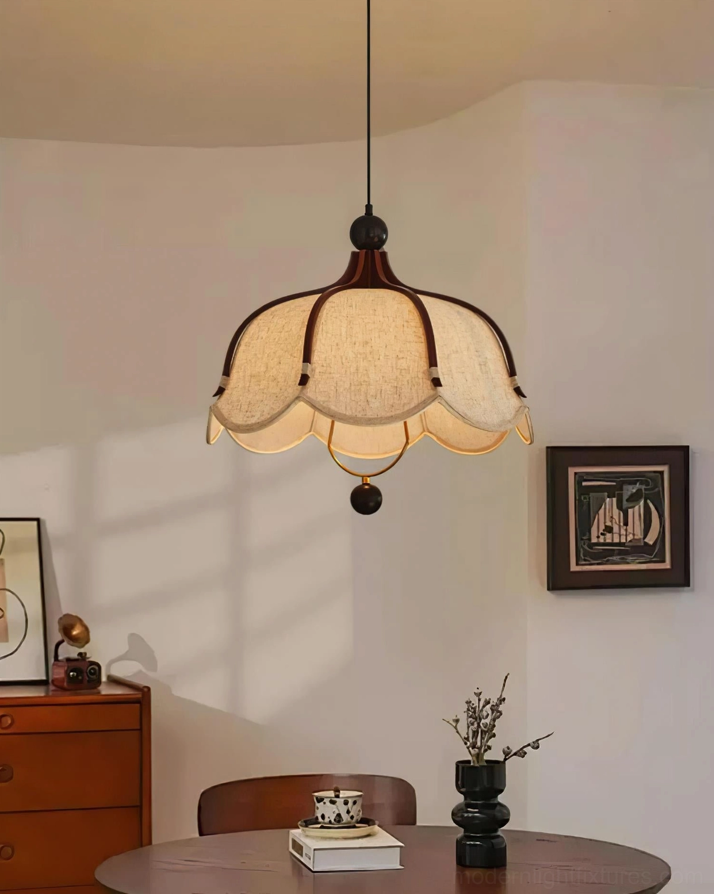 Meringa scalloped pendant light illuminated in warm dining room overhead view above round table
