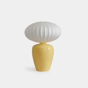 White Meringue ribbed table lamp with ceramic base on white studio background, modern minimalist design with fabric shade