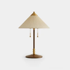 Merona pleated fabric table lamp with rattan base and brass top detail, front view on white background