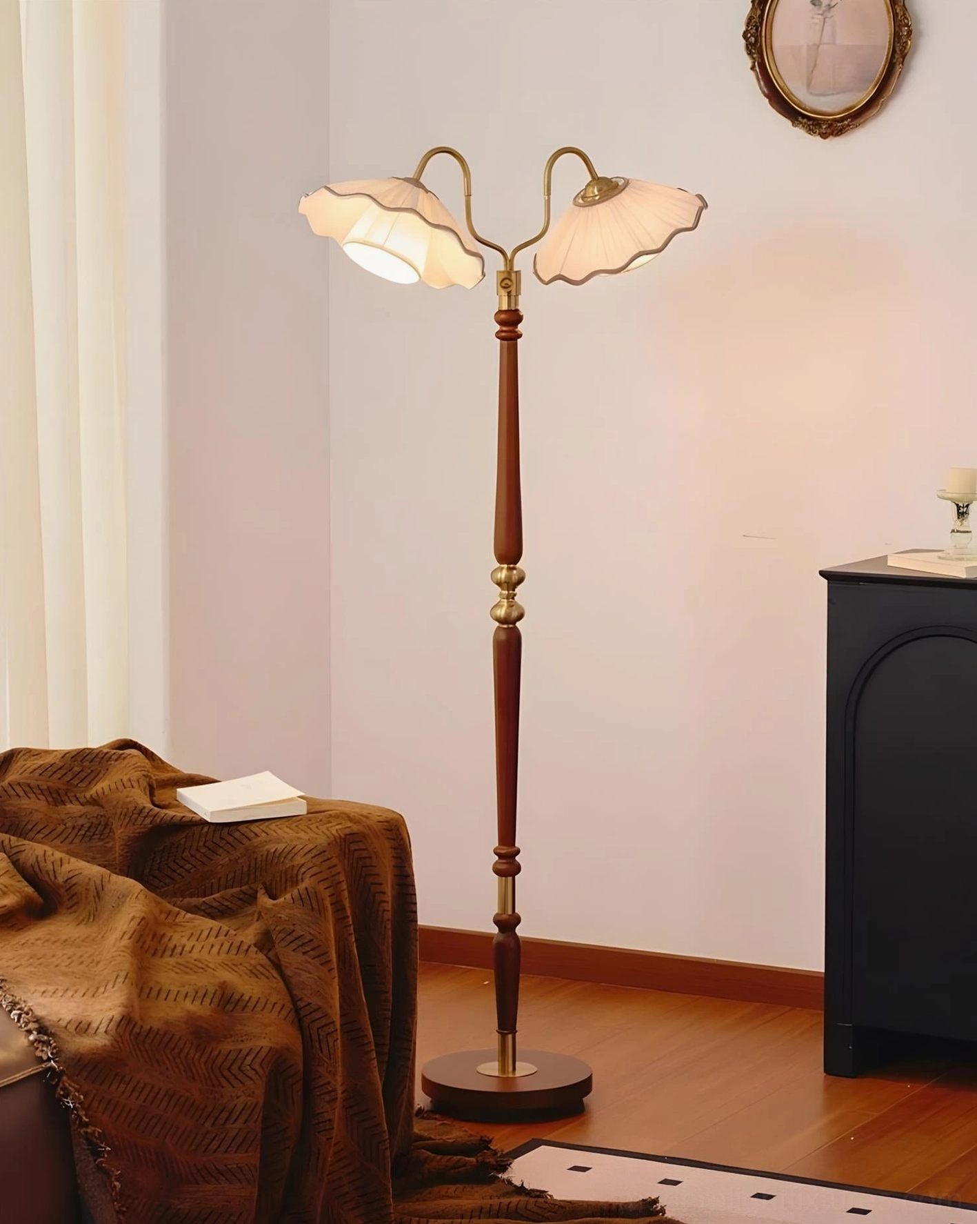 Merritt dual-shade floor lamp positioned in cozy reading corner with throw blanket, warm traditional vintage styling and soft pleated fabric shades