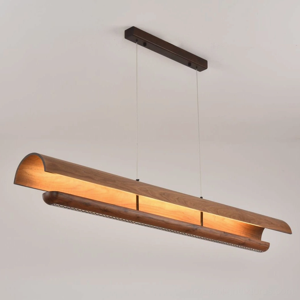 Merrow Linear Chandelier in warm industrial loft, steel cables and wood beams complementing exposed brick and metal furniture