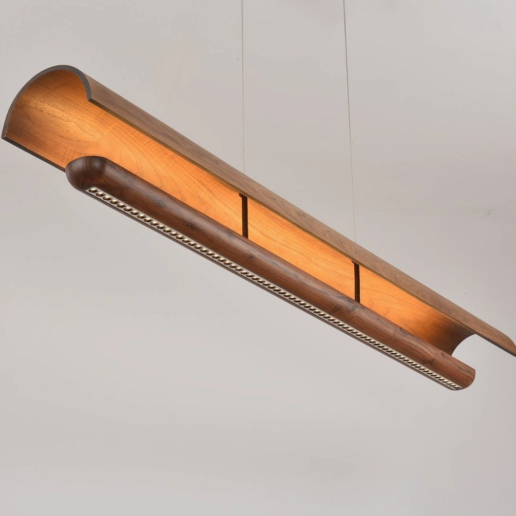 Merrow Linear Chandelier installed above long wooden dining table, mid-century modern interior design