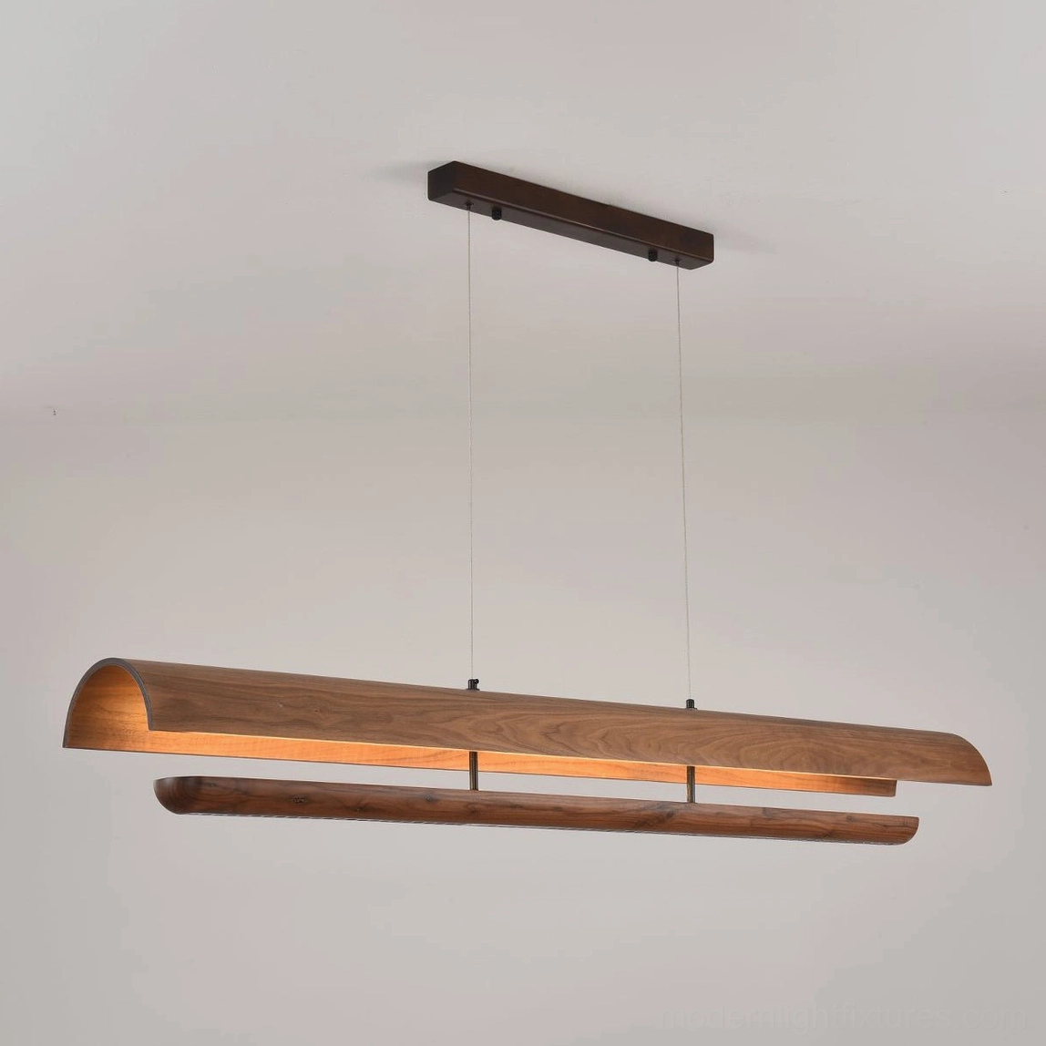 Merrow Linear Wood Pendant from below, showing warm white LED diffusion pattern and beam construction