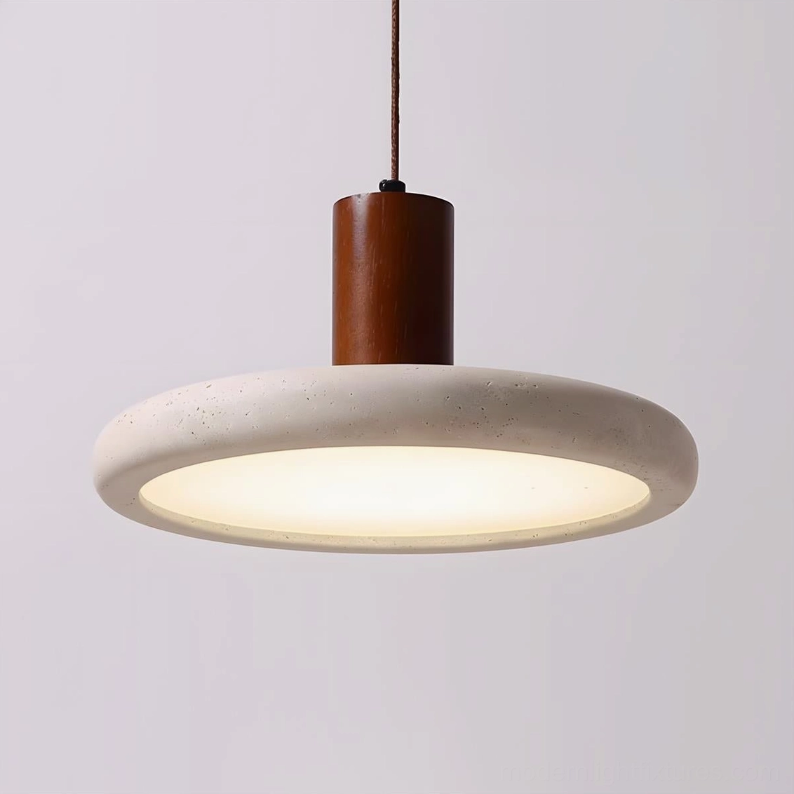 Mesa Halo pendant fixture showing natural wood cylinder support, metal canopy, and travertine diffuser in studio lighting setup
