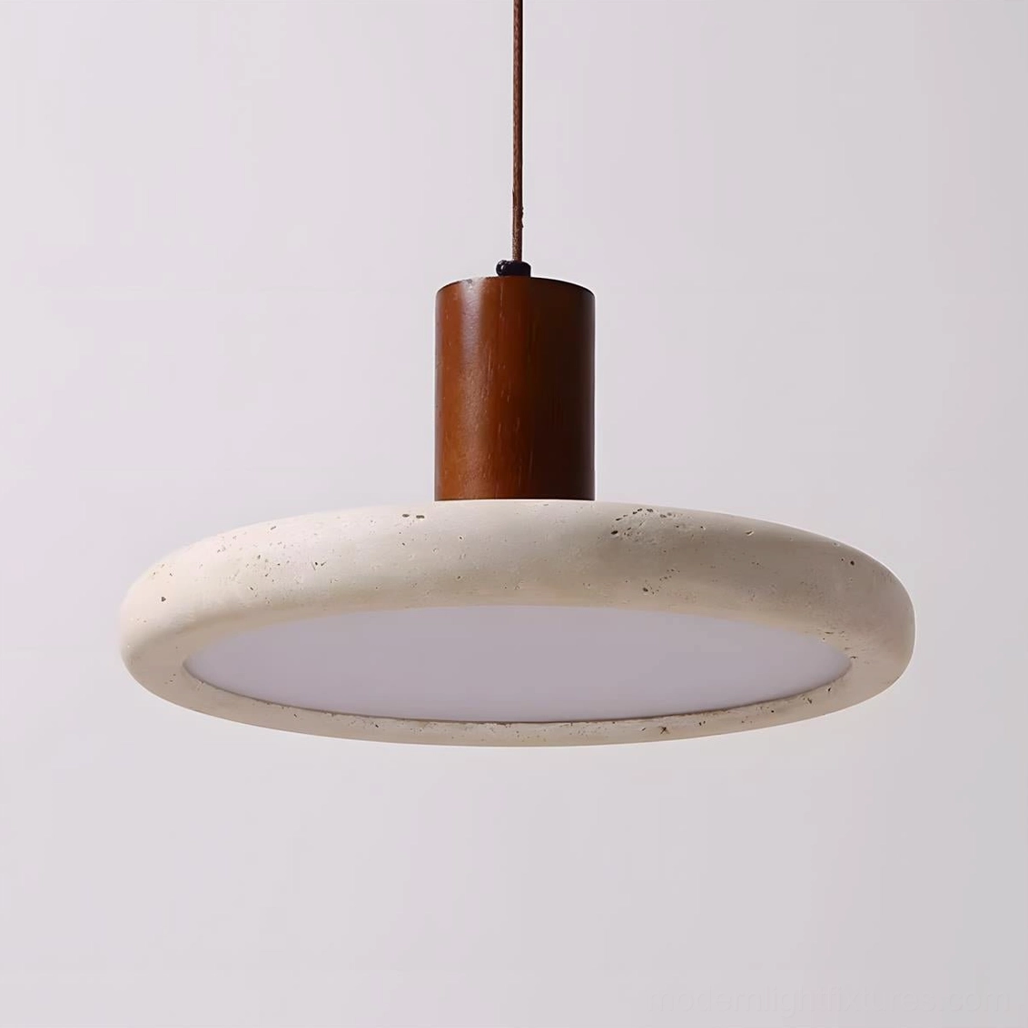 Mesa Halo modern pendant light detail showing natural travertine shade with organic texture variations and integrated warm LED technology