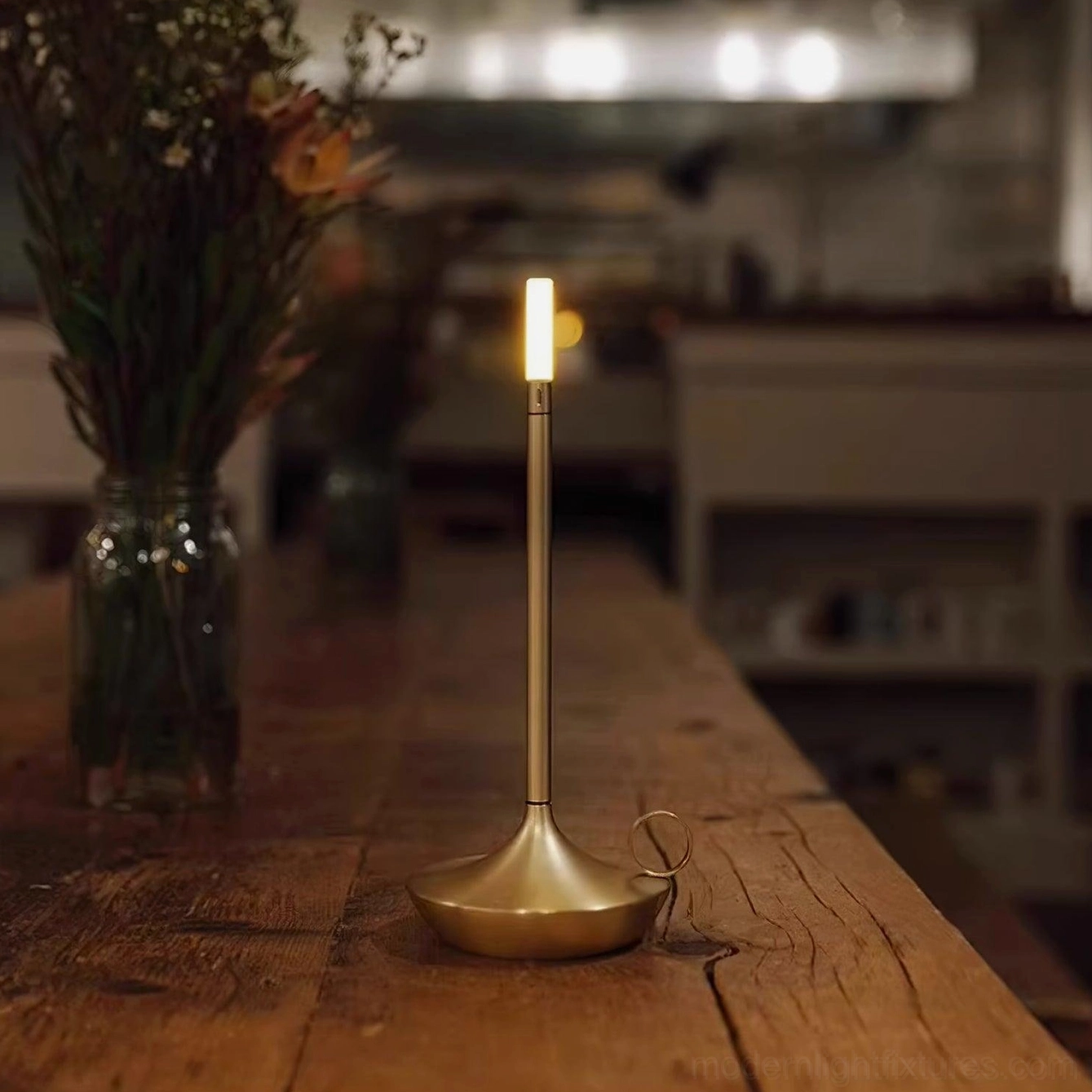 Minimalist metal LED candle table lamp integrating with industrial chic interior design aesthetic and materials