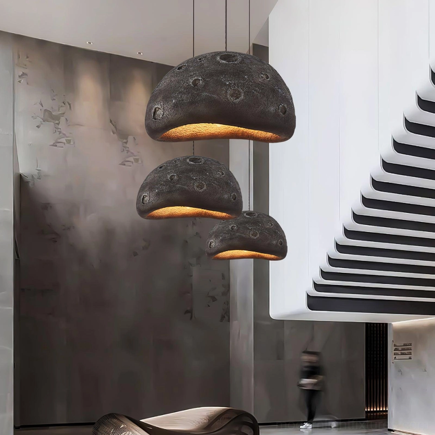 Meteorite crater pendant light showing metal and polyethylene construction materials and durability