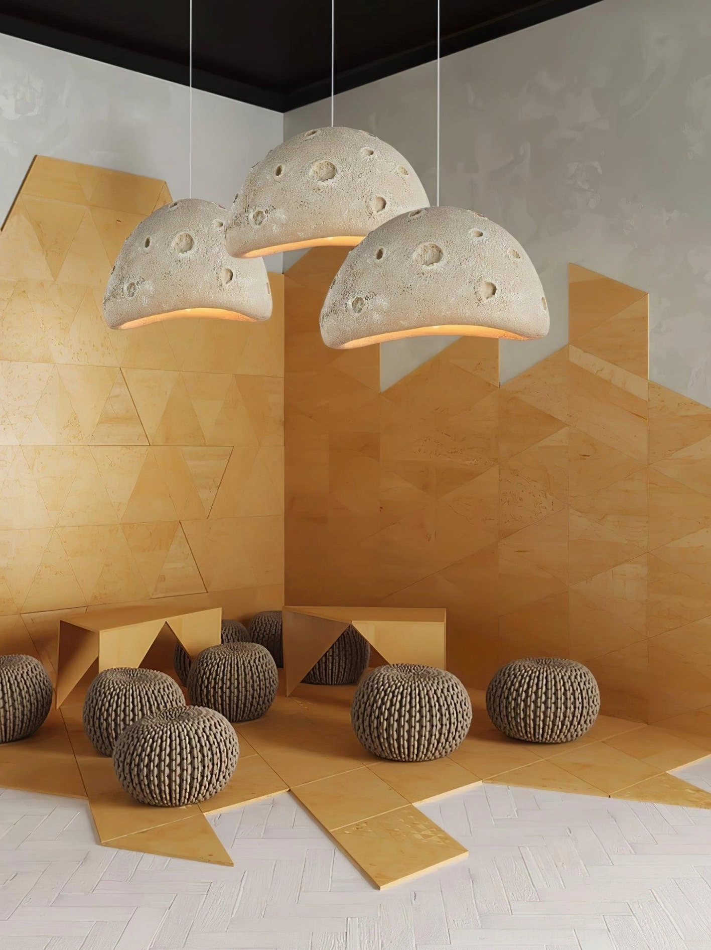 Multiple meteorite crater pendant lights creating layered ambient lighting design in open floor plan space