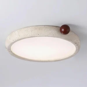 Close-up detail of Metra ceiling light frosted acrylic diffuser and natural stone surface texture