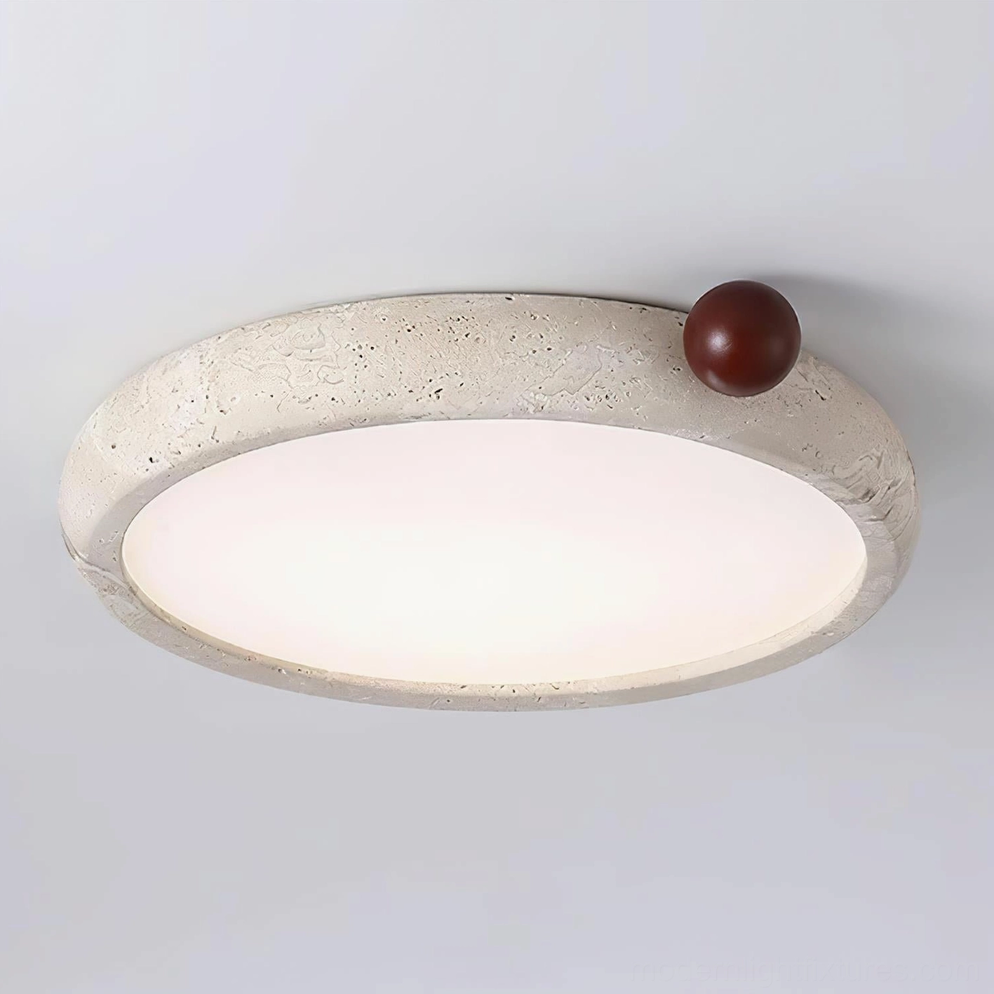 Close-up detail of Metra ceiling light frosted acrylic diffuser and natural stone surface texture