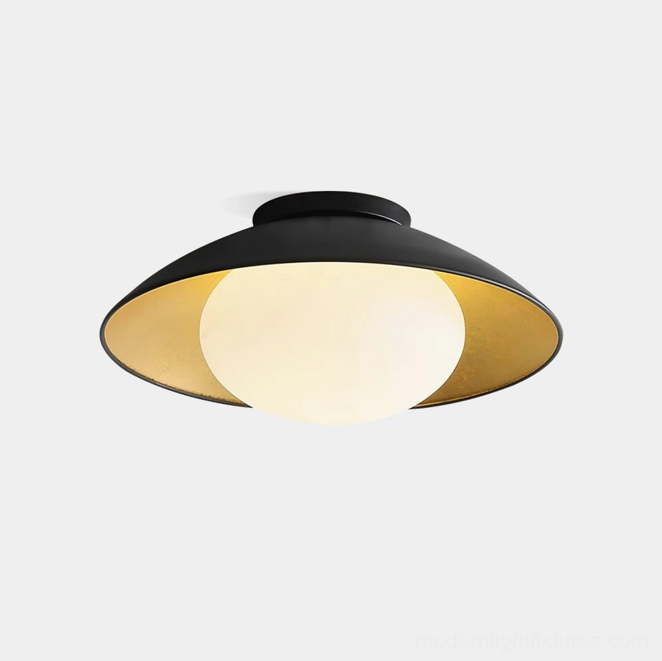 Mezo modern flush mount ceiling light with matte black exterior and gold interior, front view showcase