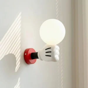 Red and white cartoon character wall sconce creating soft shadow on residential wall with window light