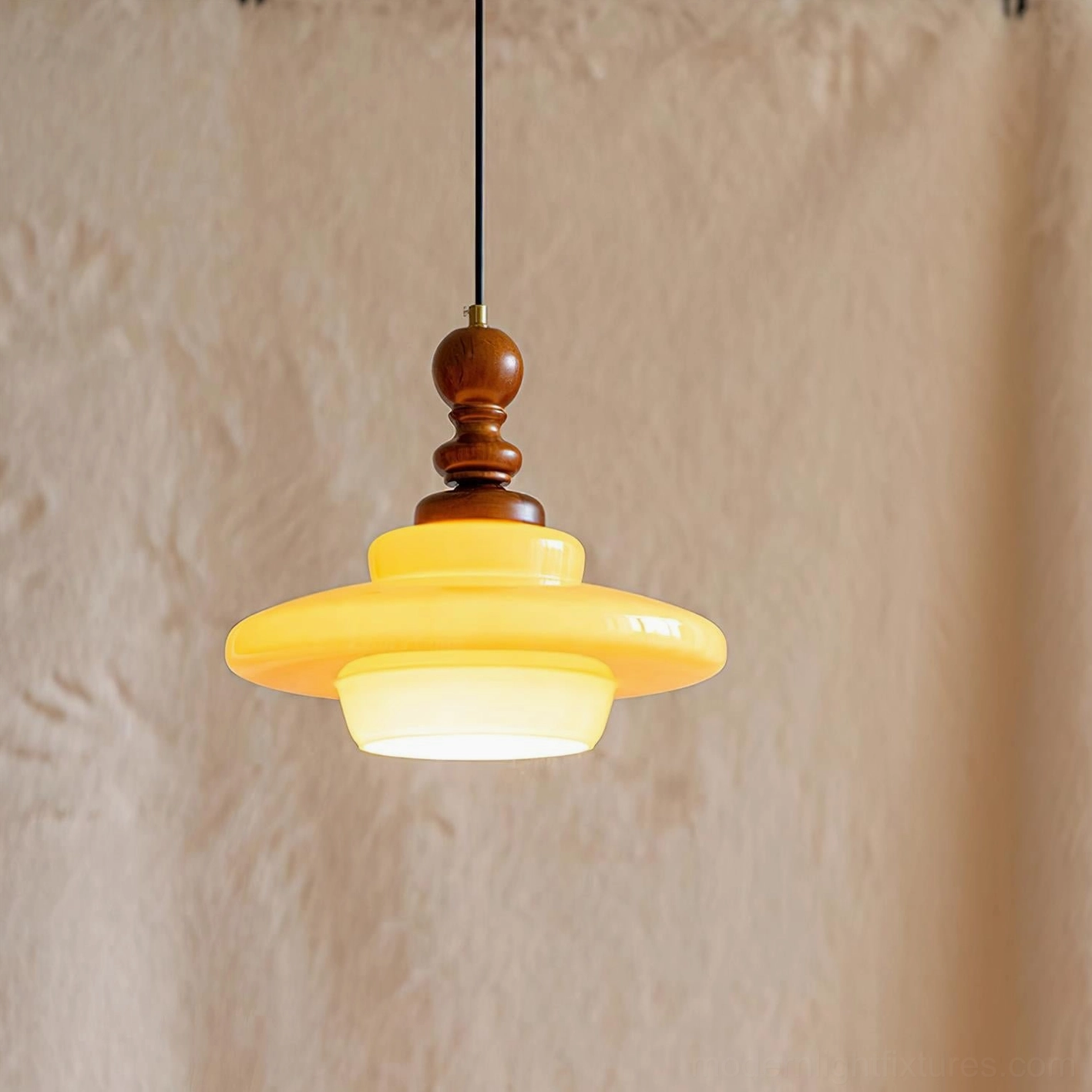 Mid-century modern pendant light with amber glass shade and natural wood hardware, interior ambiance lighting view