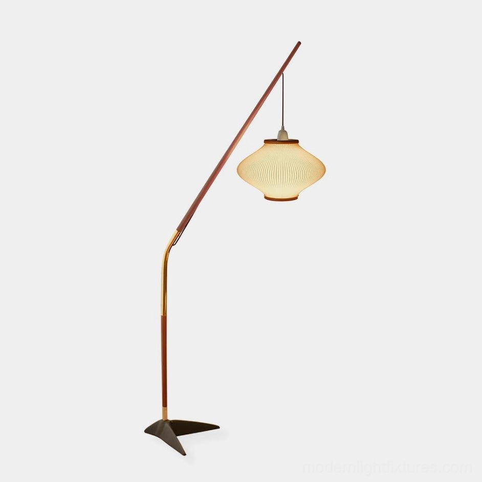 Mid-century arc floor lamp with walnut wood pole, brass accents, and black triangular metal base, front studio view