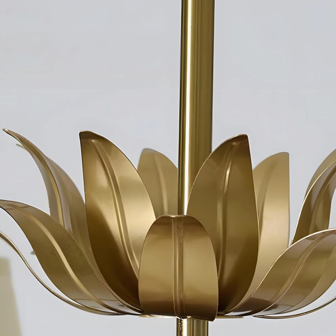 Mid-century modern chandelier detail shot showing pleated fabric shades and sculptural brass frame design