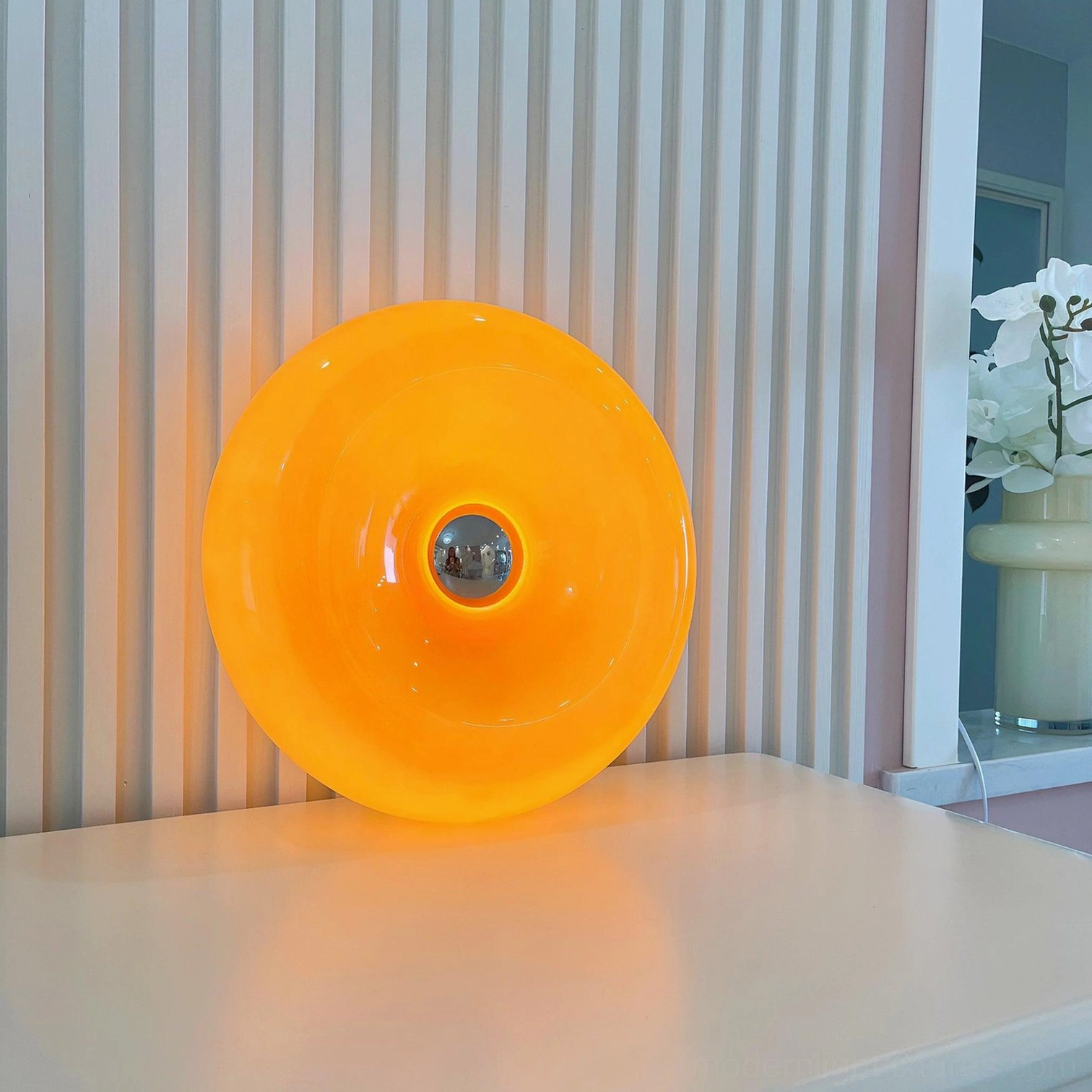 Mid-century modern donut table lamp as sculptural accent piece on home décor shelf