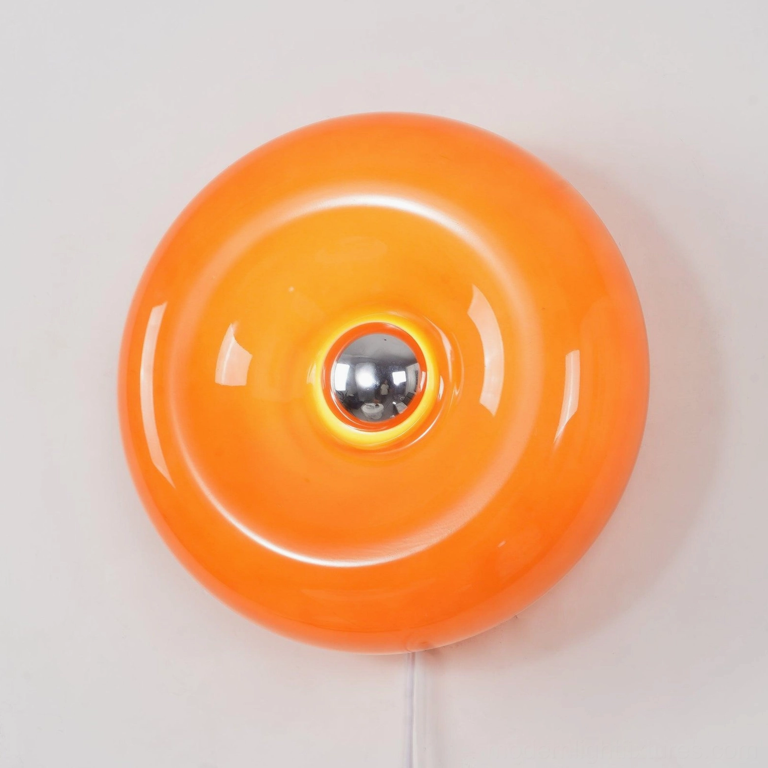 Mid-century modern donut wall lamp with glossy orange glass disc and industrial metal hardware