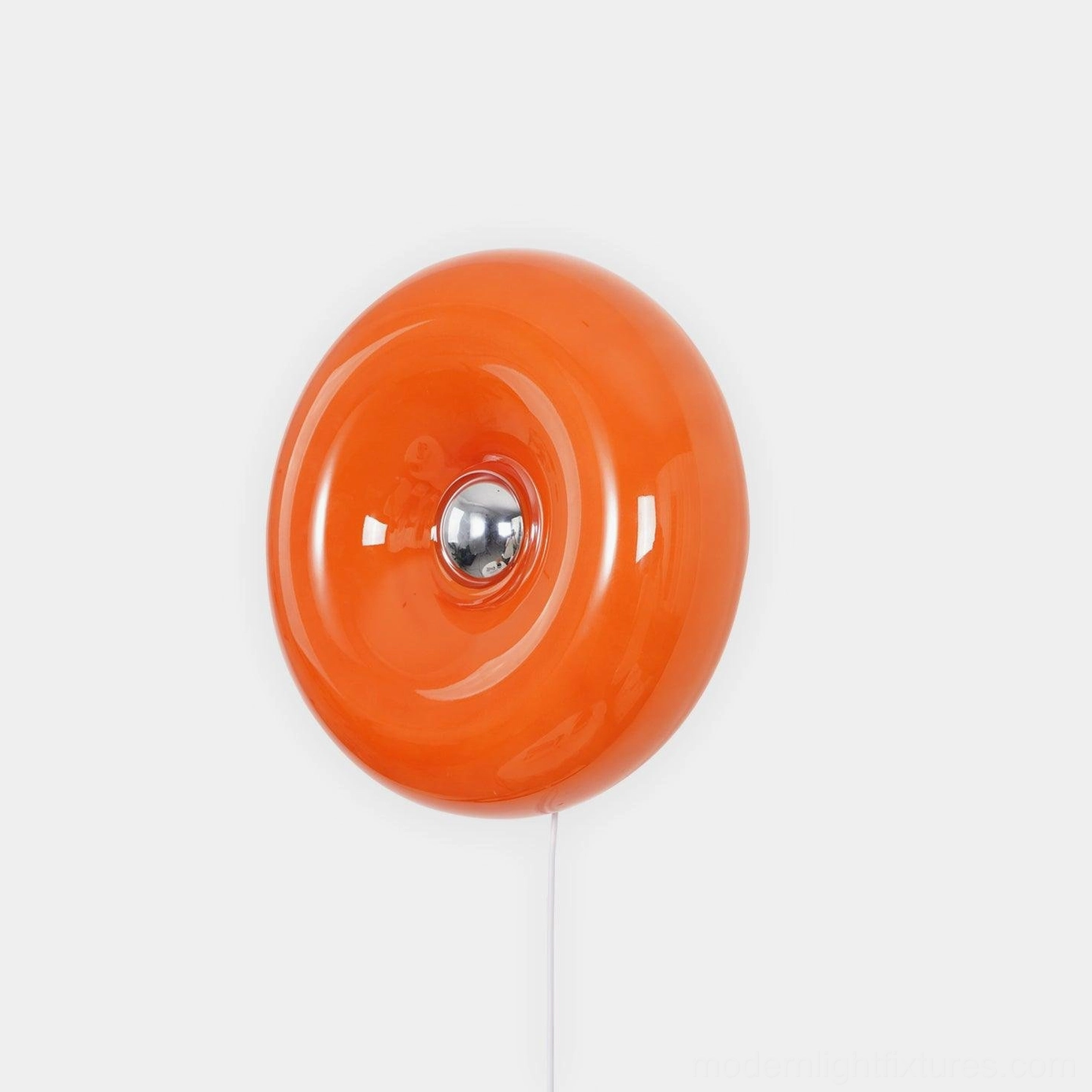 Orange mid-century modern donut wall sconce with glossy glass disc and silver metal base, front studio view