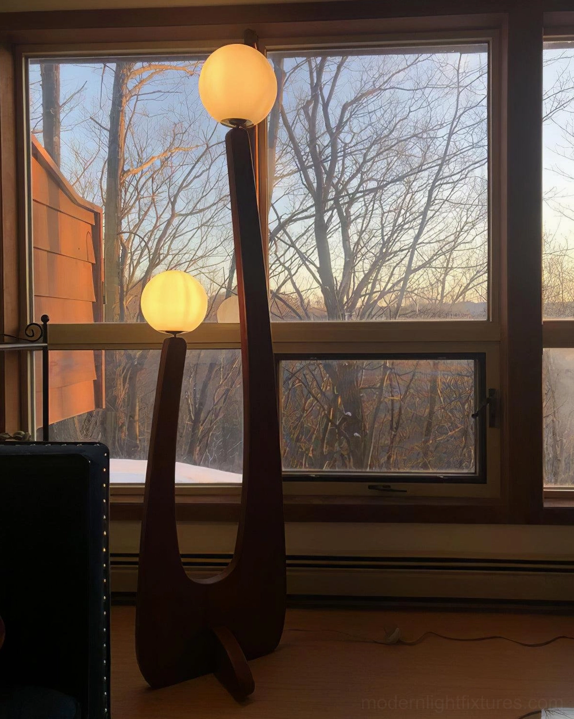 Mid-century modern floor lamp in studio setting highlighting solid oak construction and design proportions