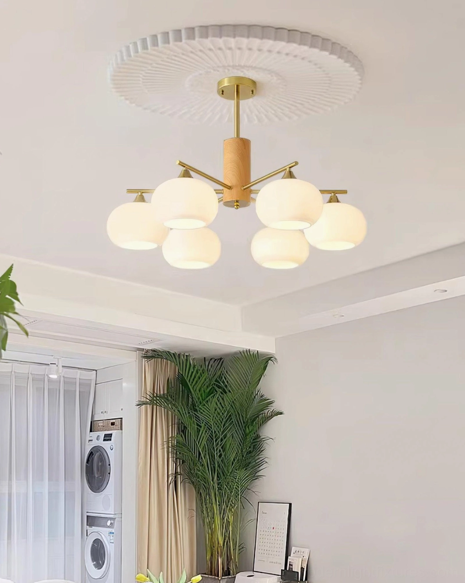 Compact 6-head glass chandelier with brass wood frame creating warm ambient lighting in modern room