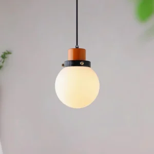 Aira retro pendant light suspended in modern interior with green foliage wall decor warm ambient glow