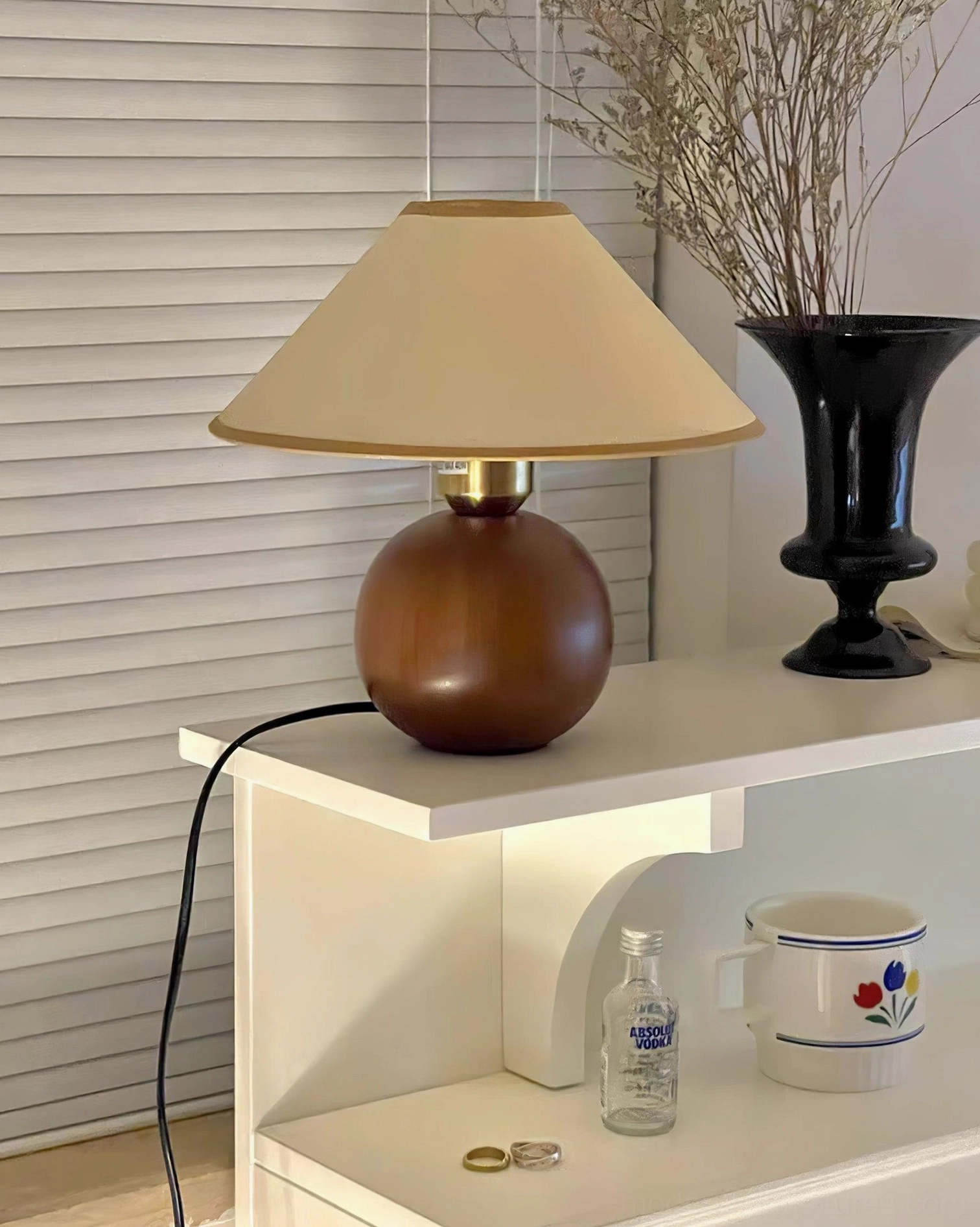 Mid-century modern table lamp base detail, showcasing walnut wood craftsmanship and finish