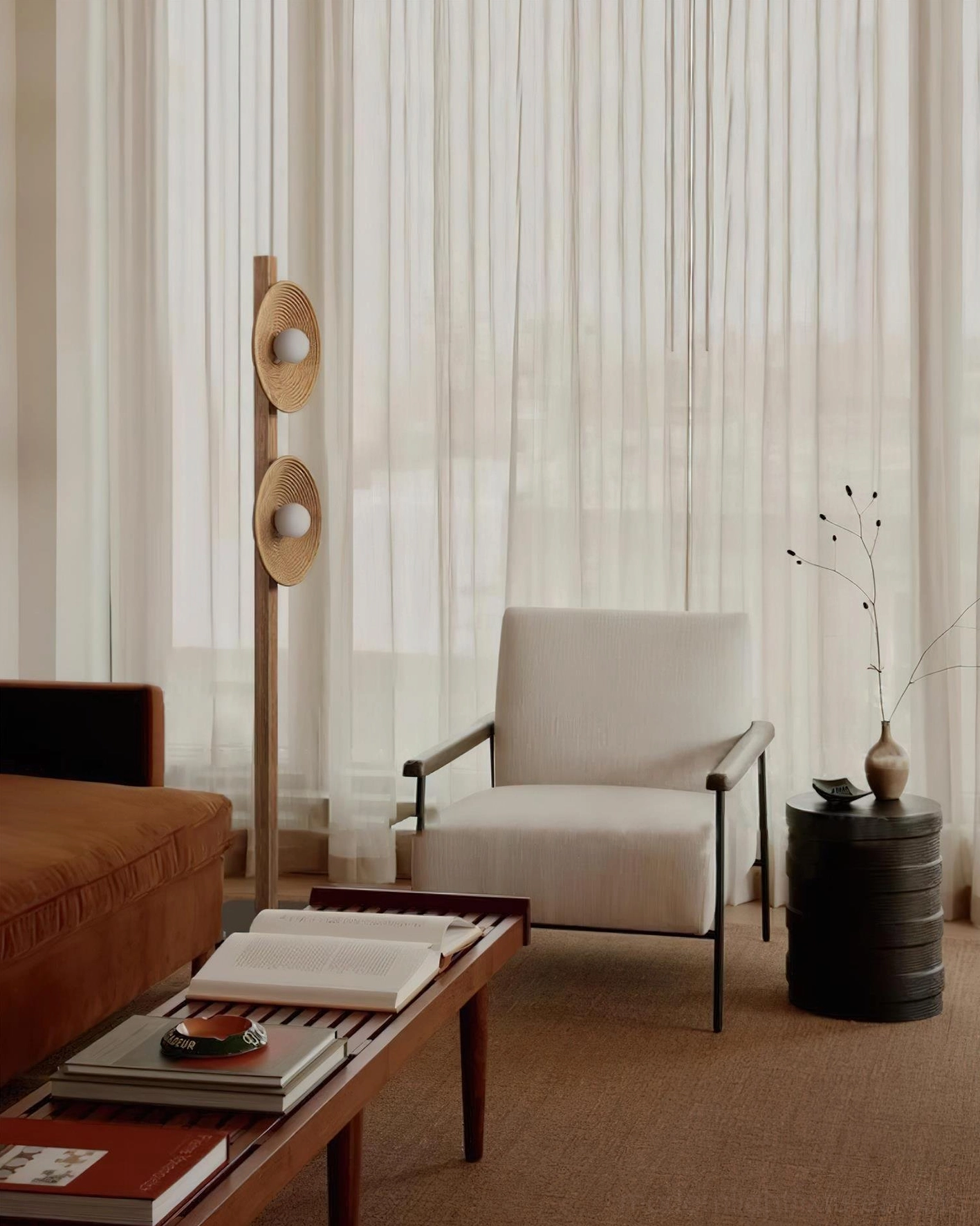 Modern geometric floor lamp placed in cozy residential lounge near armchair and coffee table