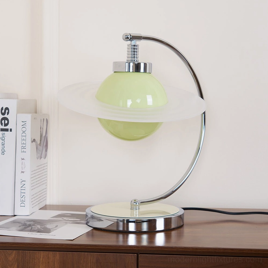 Contemporary green table lamp displayed on home interior side cabinet with decorative books and minimalist styling