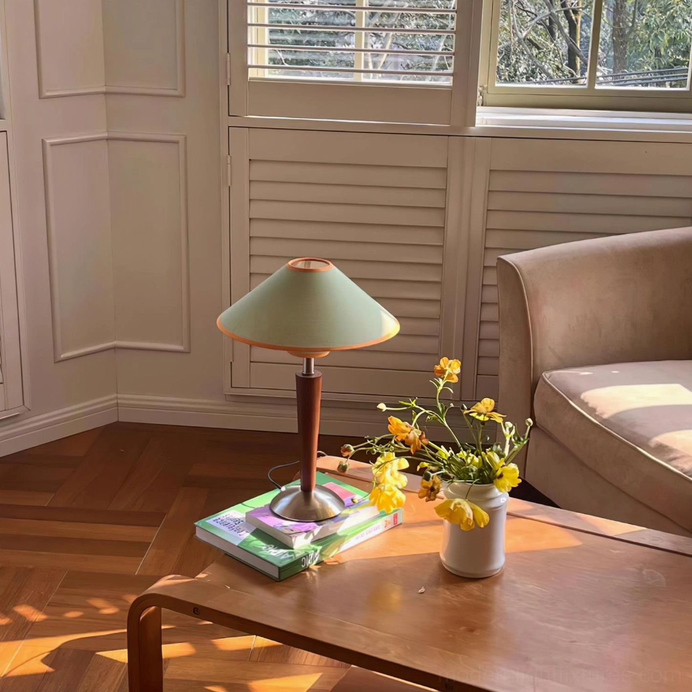 Wooden pole table lamp on vintage living room coffee table with stacked books and yellow floral arrangement
