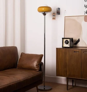 Tall chrome floor lamp with caramel amber shade in retro living room - eye-level perspective