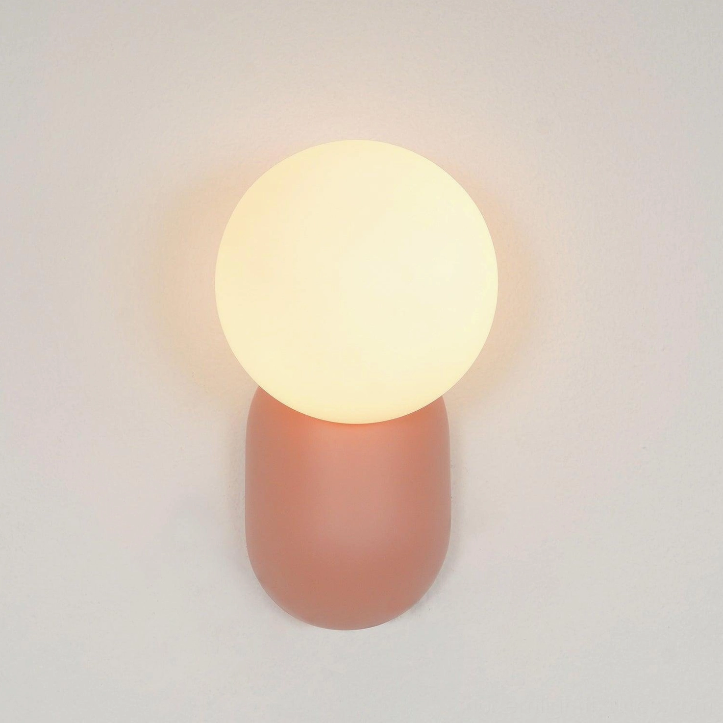 Cantilever wall sconce paired with mid-century modern furniture in minimalist interior composition