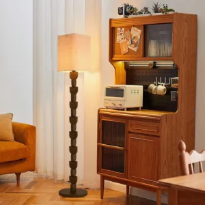 Modern wood floor lamp with warm lighting in retro mid-century living room with vintage wooden furniture