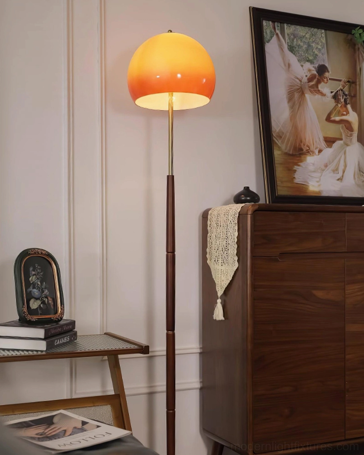 Mid-century mushroom floor lamp paired with wooden furniture and framed artwork in retro living space